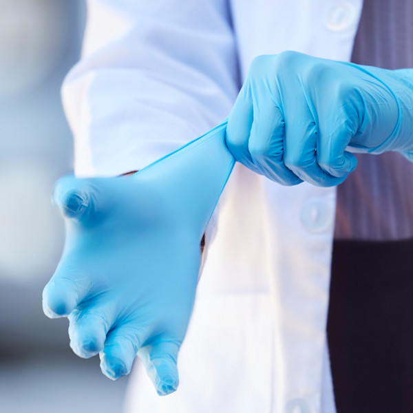 doctor putting on nitrile gloves
