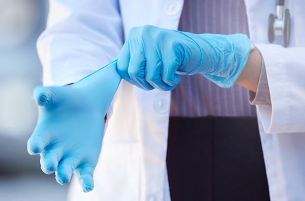 Doctor donning nitrile gloves